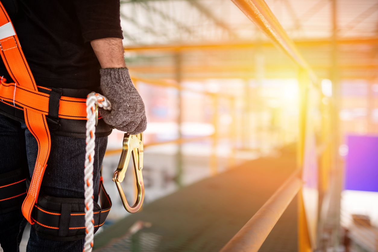 Construction worker wearing safety harness and safety line Fall Protection Solutions
